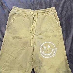 Yellow and White Athletic Shorts with Smiley Face Design